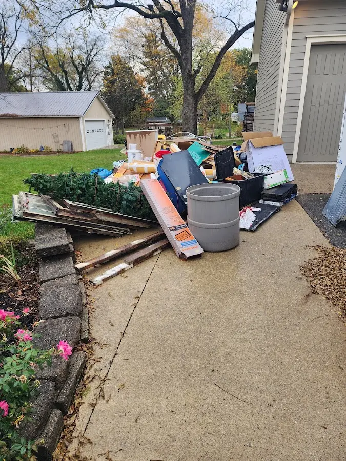 Dumpster being loaded with debris for 12 Yard Dumpster Rental in Tillmans Corner